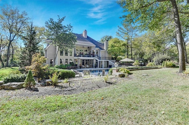 rear view of property with a patio area and a lawn