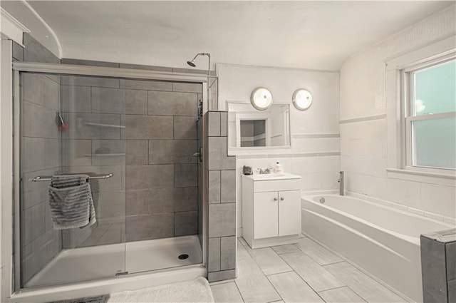 bathroom with tile patterned floors, vanity, and independent shower and bath