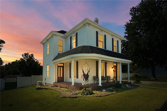 view of front facade with a yard and a porch