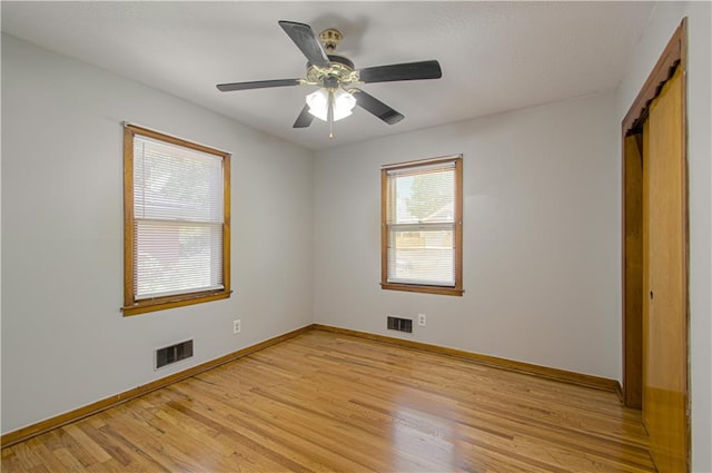 unfurnished bedroom featuring light wood-type flooring, a closet, and ceiling fan