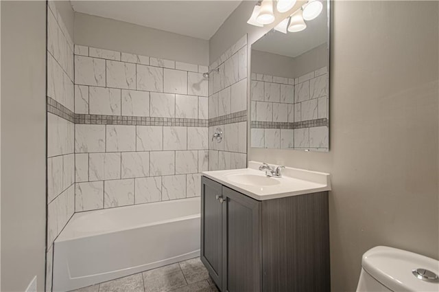 full bathroom featuring tile patterned floors, vanity, toilet, and tiled shower / bath