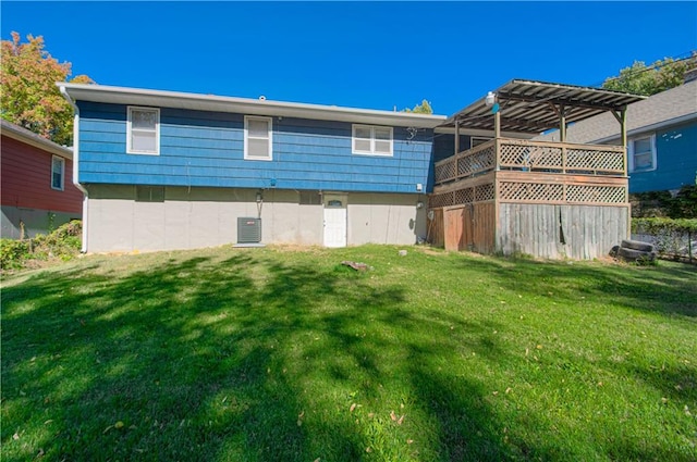 back of house with a lawn and a wooden deck