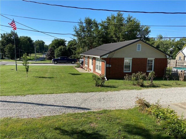 view of side of property with a lawn