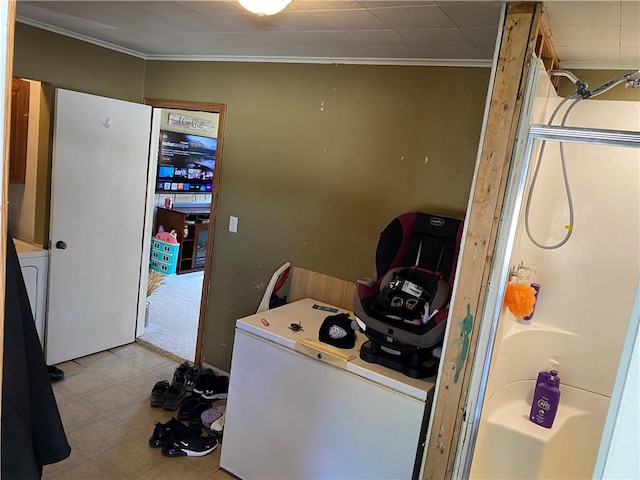 laundry area with ornamental molding