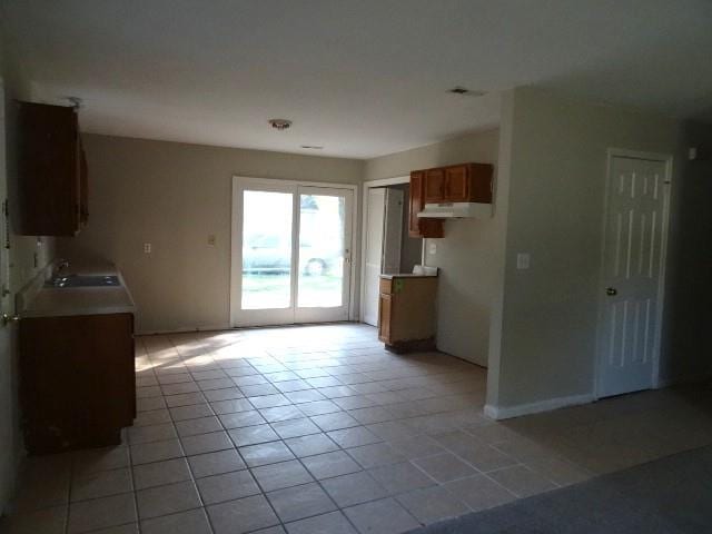 kitchen with sink and light tile patterned flooring