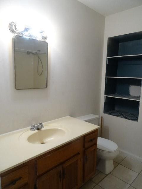 bathroom featuring toilet, vanity, and tile patterned floors