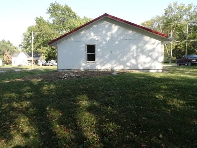 view of home's exterior with a lawn