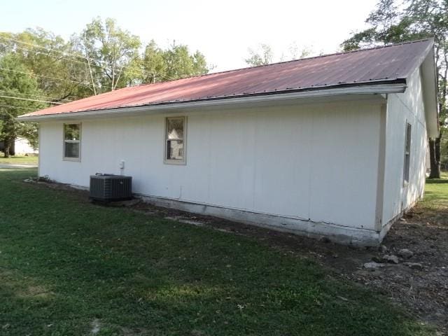 view of home's exterior with a yard and central air condition unit