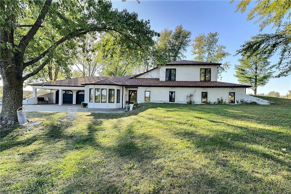 rear view of property featuring a yard