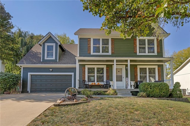 view of front of house with concrete driveway, roof with shingles, an attached garage, covered porch, and a front lawn