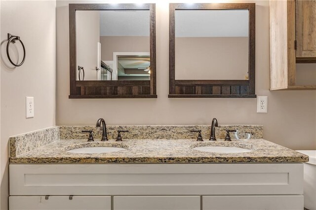 full bathroom featuring double vanity and a sink