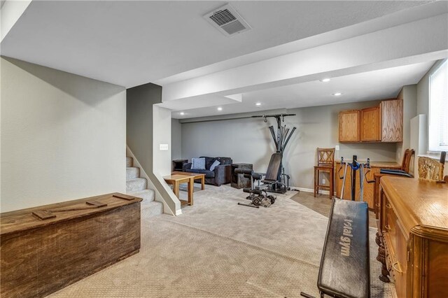 exercise area with baseboards, recessed lighting, visible vents, and light colored carpet