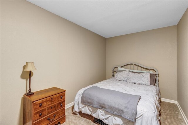 bedroom featuring carpet and baseboards