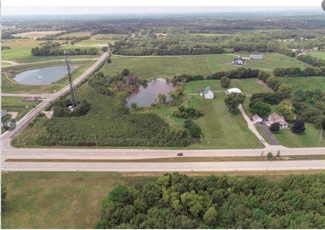 birds eye view of property with a water view and a rural view