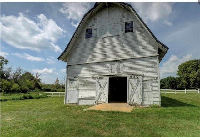 back of house with a yard and an outbuilding