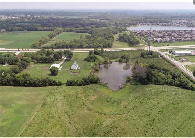 birds eye view of property with a water view and a rural view