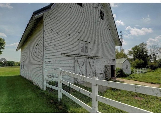 view of property exterior with a lawn