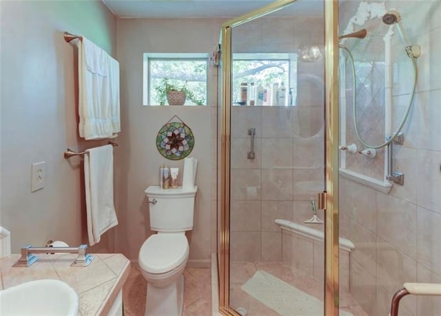 bathroom with vanity, walk in shower, toilet, and tile patterned flooring