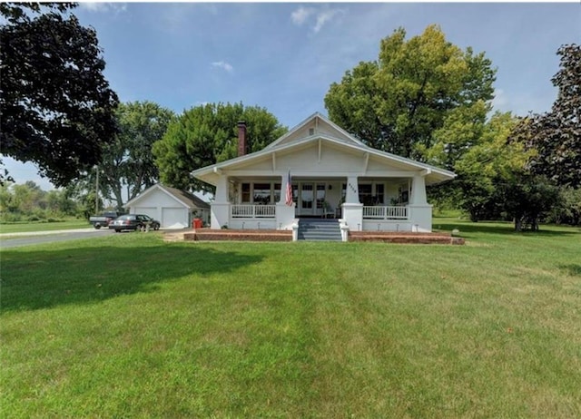 view of front of home with a front yard and covered porch