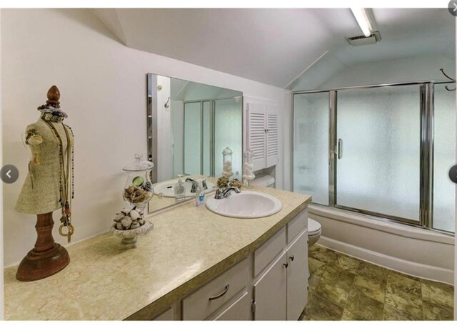 full bathroom with vanity, toilet, combined bath / shower with glass door, and lofted ceiling