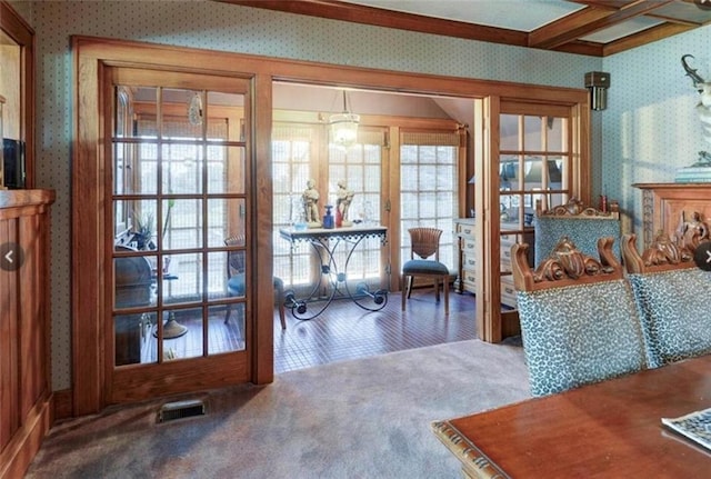 interior space featuring beam ceiling and carpet floors