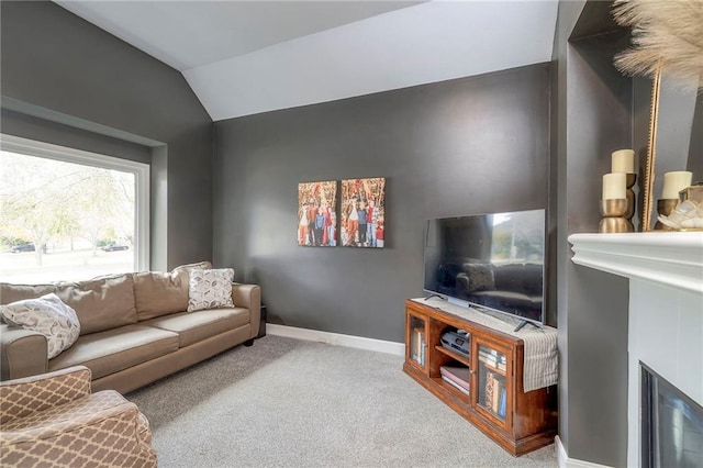 living room with light carpet, vaulted ceiling, and a fireplace