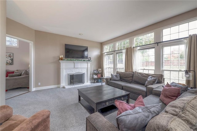 living room featuring a brick fireplace and carpet flooring