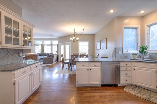 kitchen featuring white cabinets, stainless steel dishwasher, sink, and dark hardwood / wood-style flooring