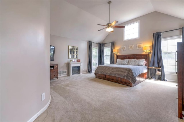 carpeted bedroom with high vaulted ceiling and ceiling fan