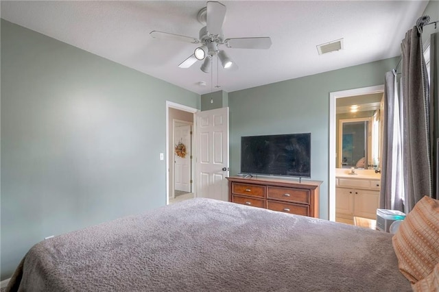 bedroom featuring sink, connected bathroom, and ceiling fan