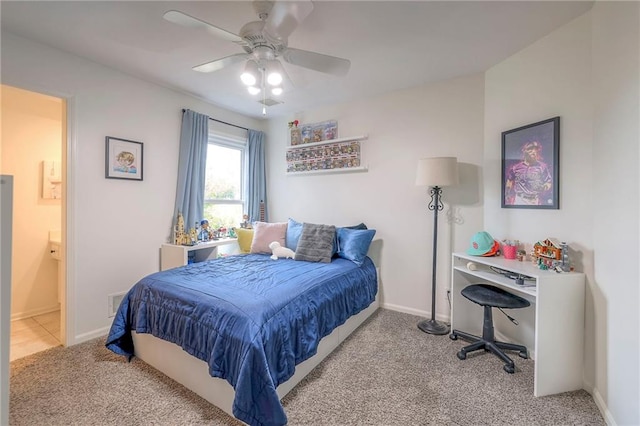 bedroom featuring ensuite bath, carpet floors, and ceiling fan