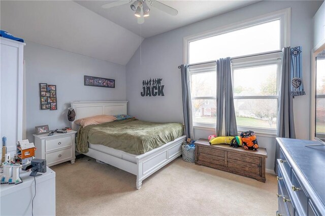 carpeted bedroom featuring ceiling fan and vaulted ceiling