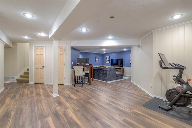 workout area with dark wood-type flooring and a textured ceiling