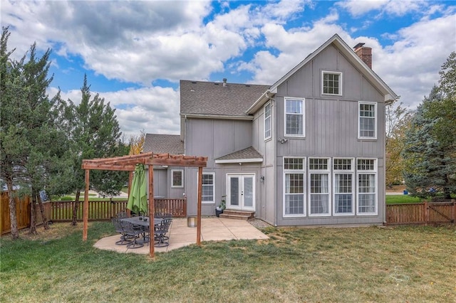 rear view of house with a patio, a lawn, and a pergola