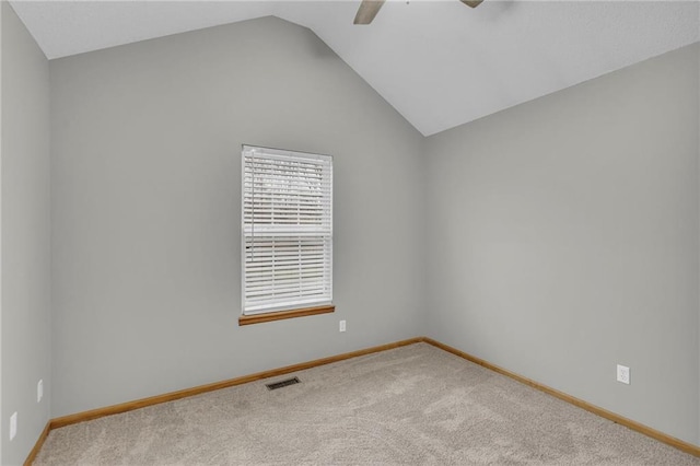 carpeted spare room featuring ceiling fan and vaulted ceiling