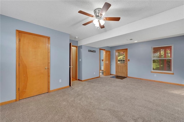 unfurnished room with light carpet, a textured ceiling, and ceiling fan