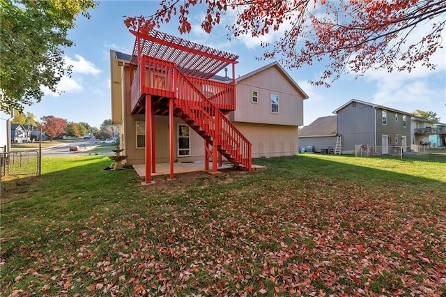 back of house with a lawn, a patio area, and a wooden deck