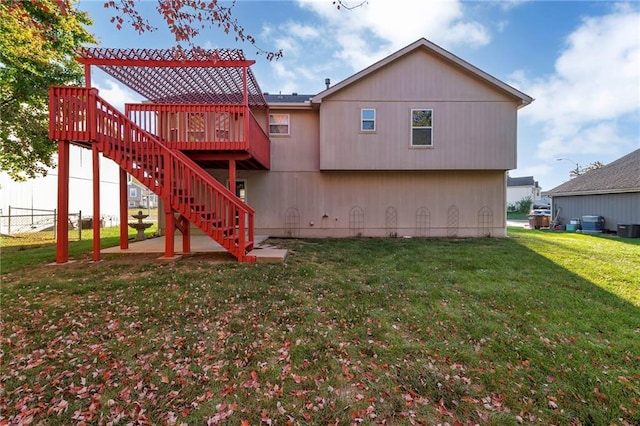 back of house with a lawn and a wooden deck