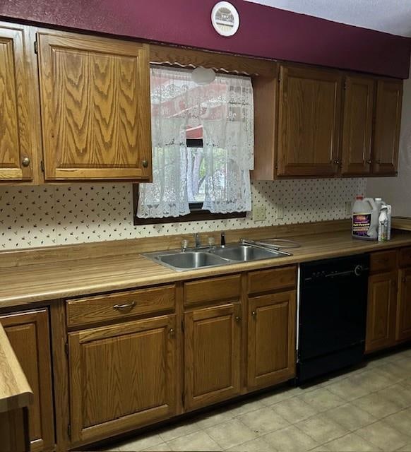 kitchen featuring black dishwasher, sink, backsplash, and wooden counters