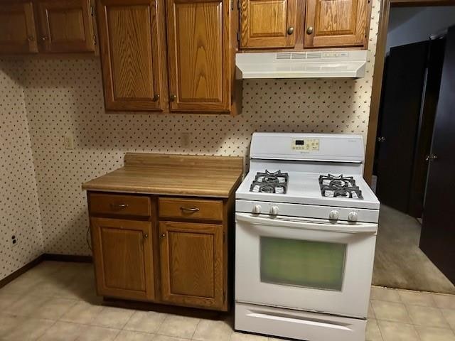 kitchen with white range with gas stovetop