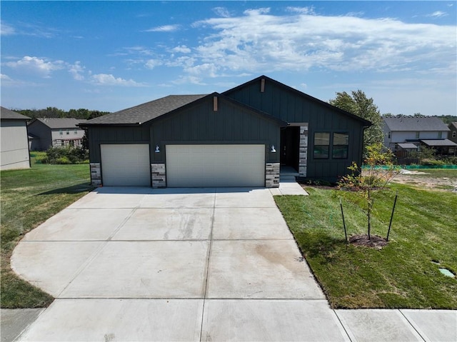 view of front of home featuring driveway, stone siding, board and batten siding, and a front yard