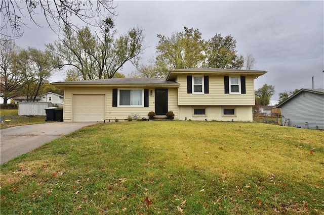 split level home featuring a garage and a front lawn