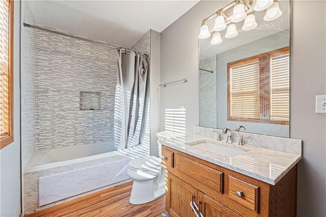 full bathroom featuring toilet, wood-type flooring, vanity, and shower / bath combo with shower curtain