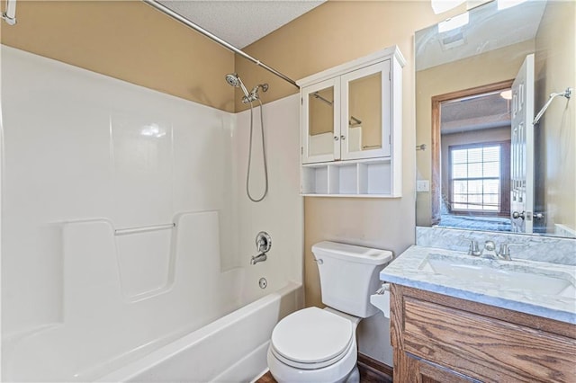 full bathroom with vanity, a textured ceiling, shower / bathtub combination, and toilet