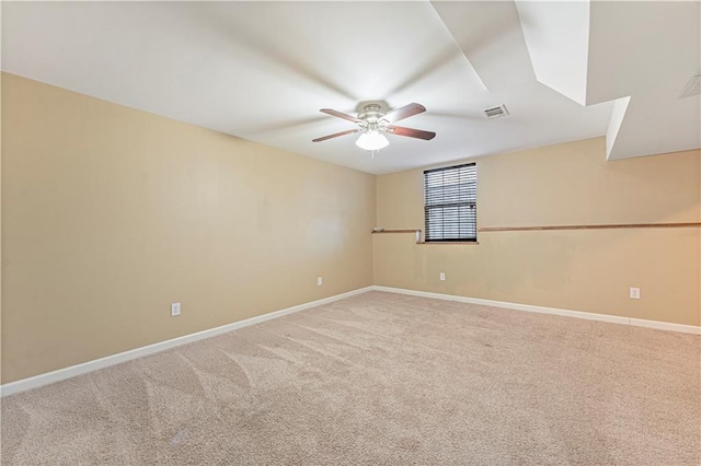 carpeted spare room with ceiling fan