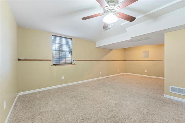 empty room featuring ceiling fan and carpet