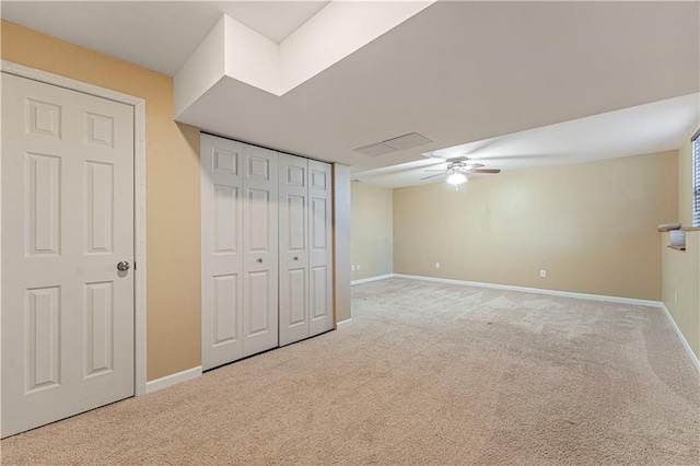 interior space with ceiling fan and carpet flooring