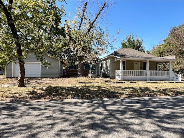 601 W 5th St, Pittsburg, KS 66762 - view of side of property with a porch, cooling unit, an outbuilding, and a detached garage