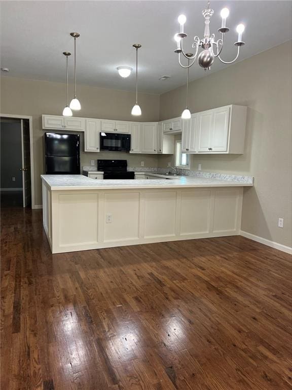 kitchen featuring black appliances, dark hardwood / wood-style flooring, kitchen peninsula, white cabinetry, and an inviting chandelier