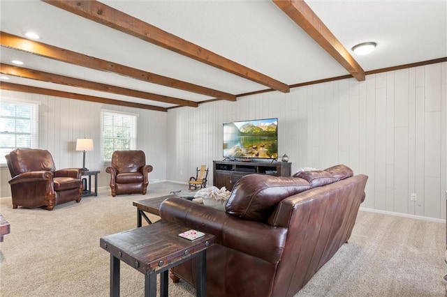 living room with beamed ceiling, carpet flooring, plenty of natural light, and wooden walls